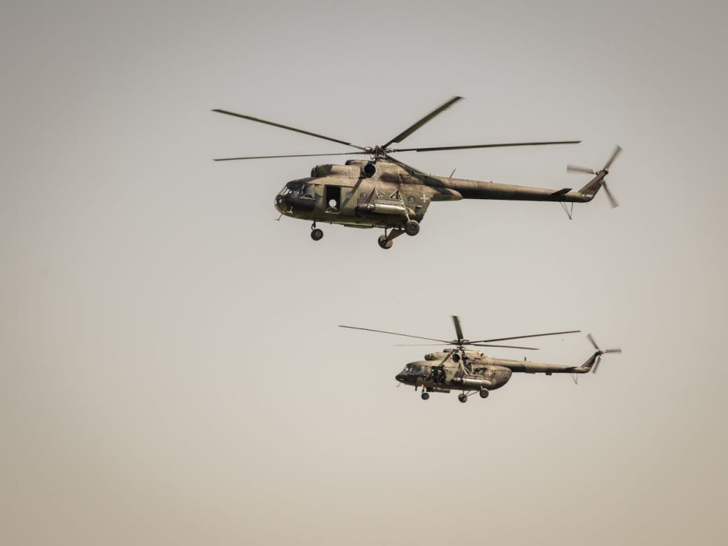 Two military helicopters flying in the sky above Belgrade, Serbia.